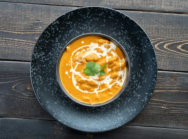 Top view of homemade Shahi Paneer on rustic wooden table, perfect for Indian cuisine lovers.