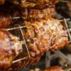 Close-up of juicy and perfectly grilled rotisserie pork, ideal for barbecue lovers.
